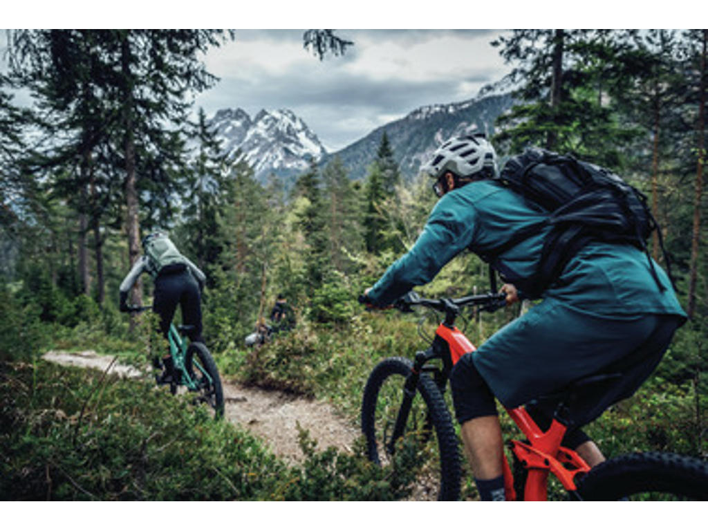 Person bærer mtb hjelm på en cykeltur ude i skoven